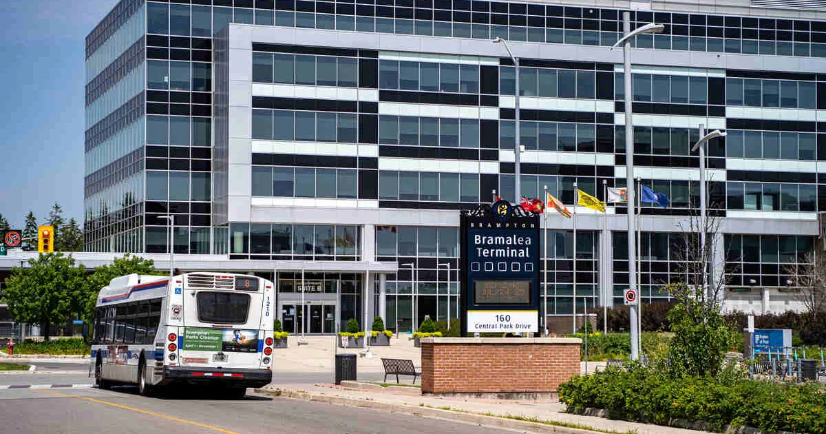 View of Bramalea Bus Terminal in Brampton, Ontario.  The Peel Region Municipal Offices building dominates the background.