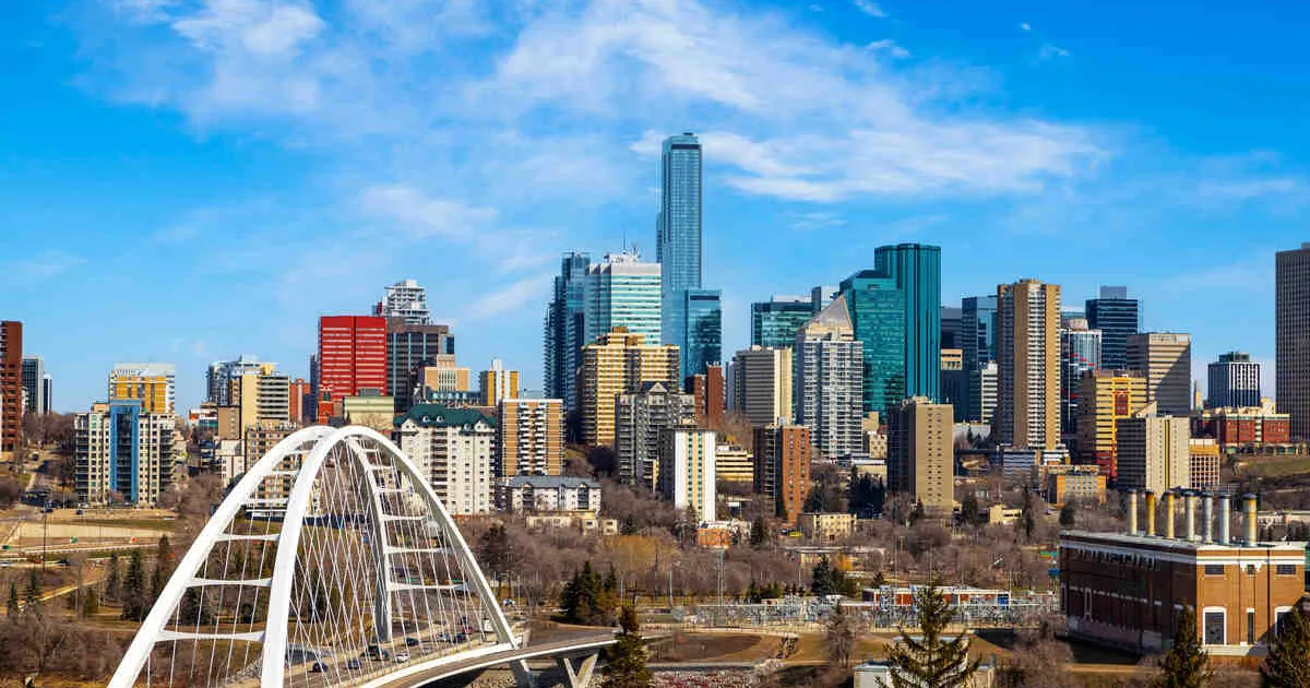 Downtown Edmonton skyline featuring the Walterdale Bridge spanning across the Saskatchewan River.