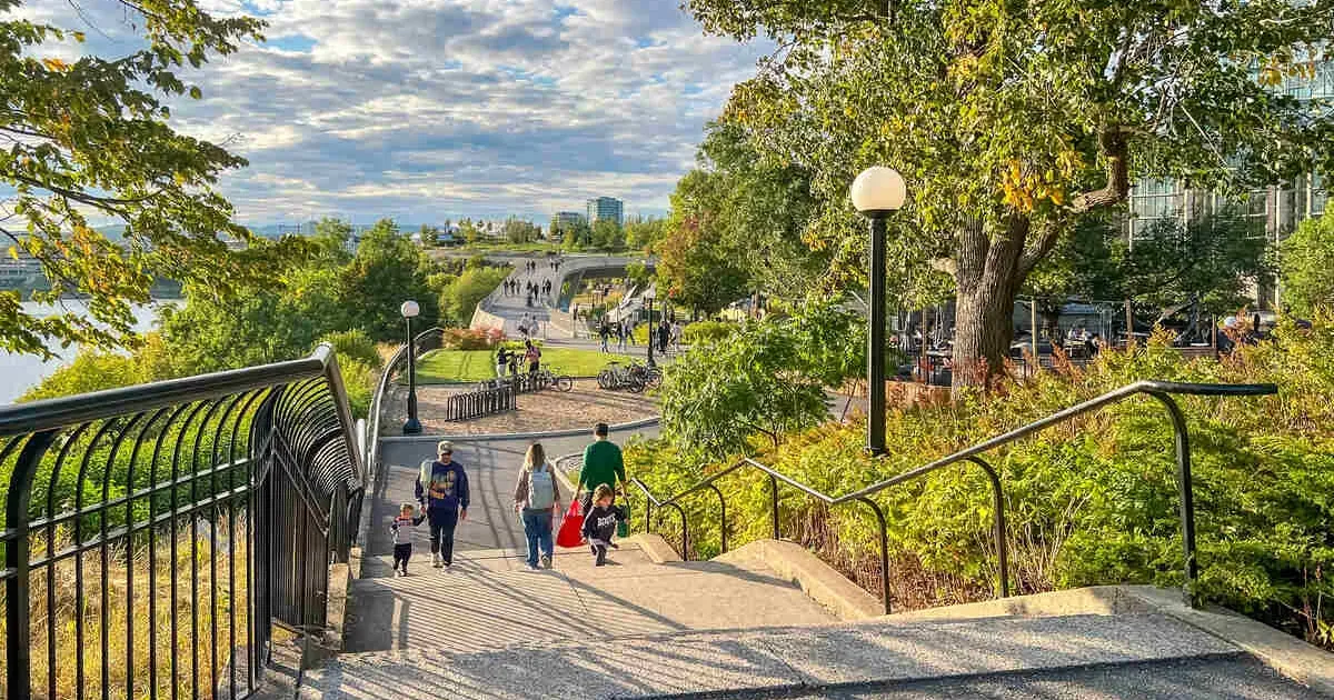 Kiweki Point park in Ottawa, Ontario showcases families descending steps amidst vibrant foliage and beautiful scenery
