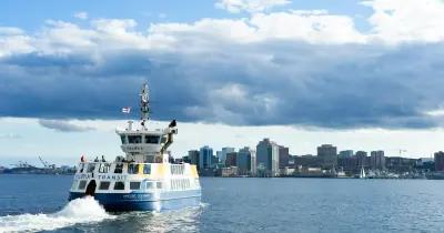 A Halifax Transit ferry crossing the harbour, with the Halifax skyline behind it